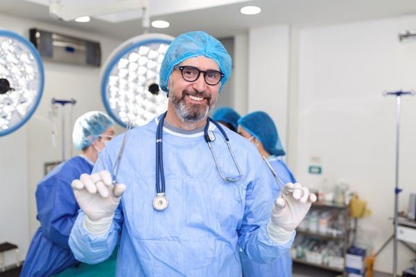 Cirujano capilar feliz por contar con un equipo médico completamente capacitado, lo cual facilita el procedimiento de implante de cabello