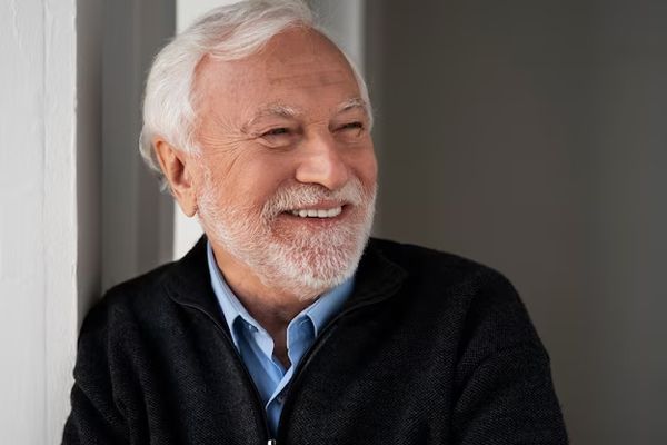 canas - hombre mayor sonriente con el pelo canoso y síntomas de alopecia