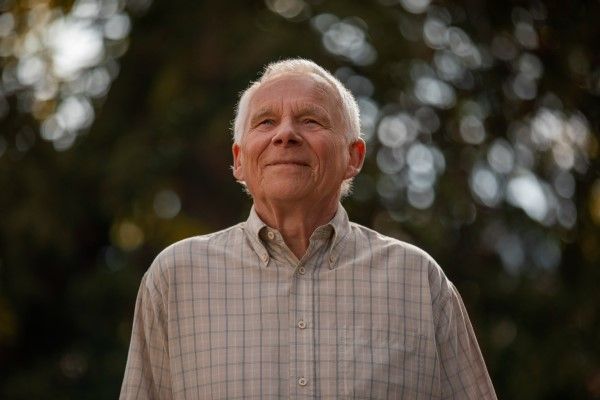 Cómo envejece nuestro pelo - hombre mayor sonriente paseando por un parque