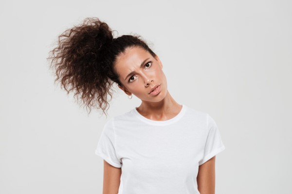 mujer blanca con pelo rizado recogido en una cola