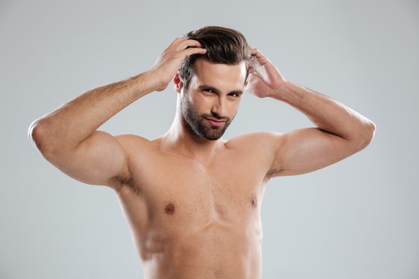 shock loss tras el injerto capilar - hombre llevándose la manos al cabello