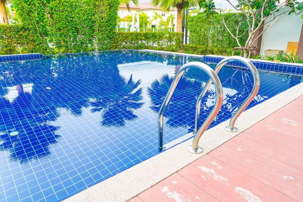 Cloro de las piscinas - Piscina cuadrada con azulejos azules y escalera de metal