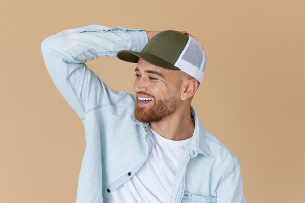 Caer el cabello - Hombre sonriente con gorra busca alternativas para preservar la salud capilar 